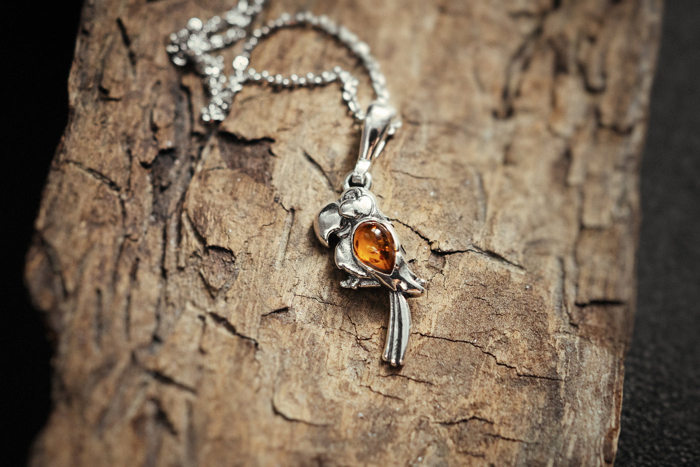 Vibrant Plumage - Silver Parrot Pendant with Baltic Amber