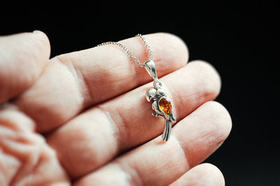 Vibrant Plumage - Silver Parrot Pendant with Baltic Amber