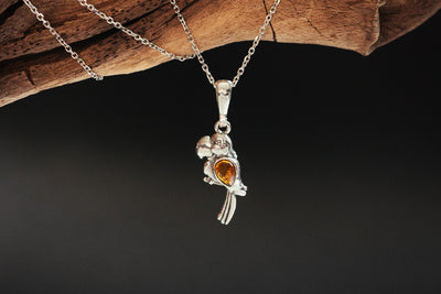 Vibrant Plumage - Silver Parrot Pendant with Baltic Amber