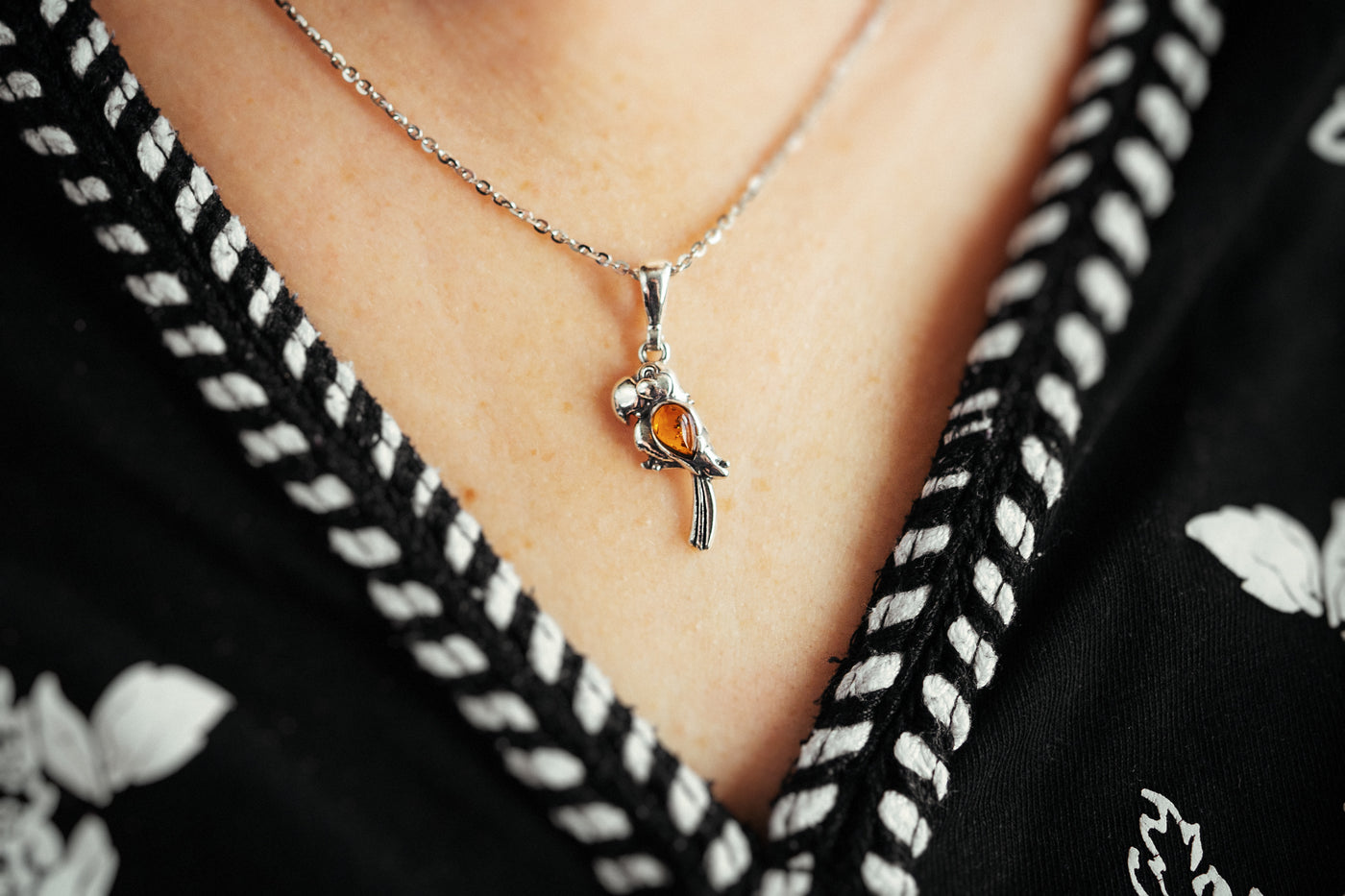 Vibrant Plumage - Silver Parrot Pendant with Baltic Amber