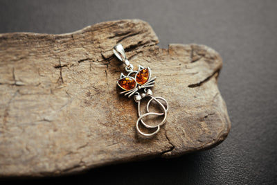 Delicate silver cat pendant.