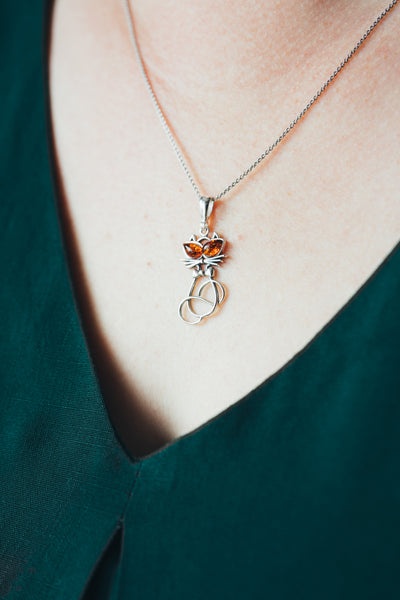 Delicate silver cat pendant.