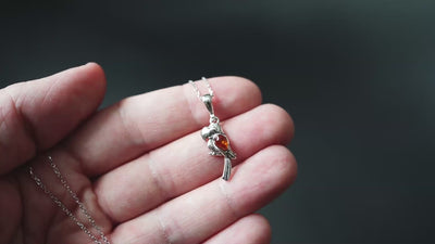 Vibrant Plumage - Silver Parrot Pendant with Baltic Amber